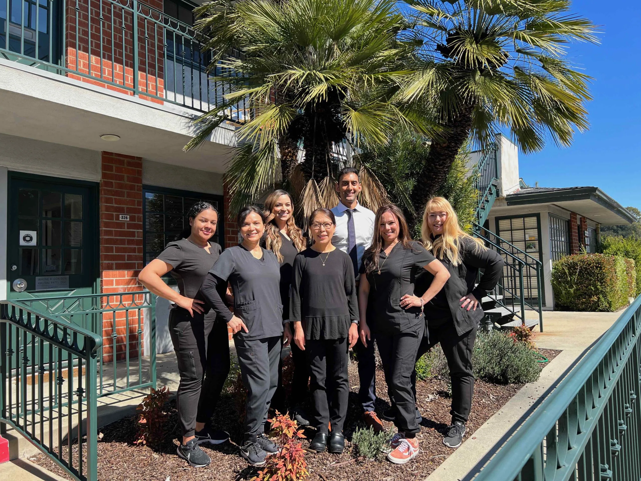 The Krutav Patel DDS dental team outside their Claremont Village office