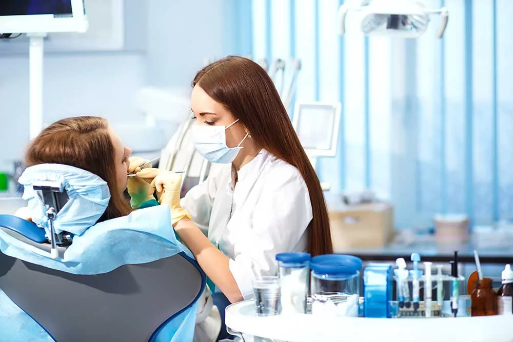 Dental hygienist performing professional teeth cleaning at Krutav Patel DDS in Claremont